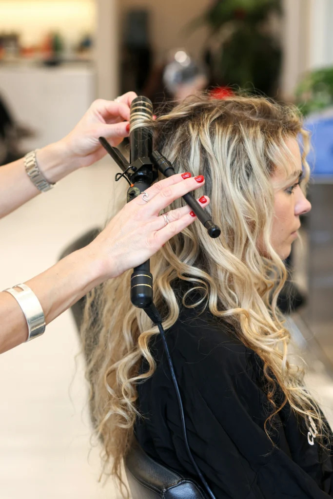 A person applying leave-in conditioner to braided hair